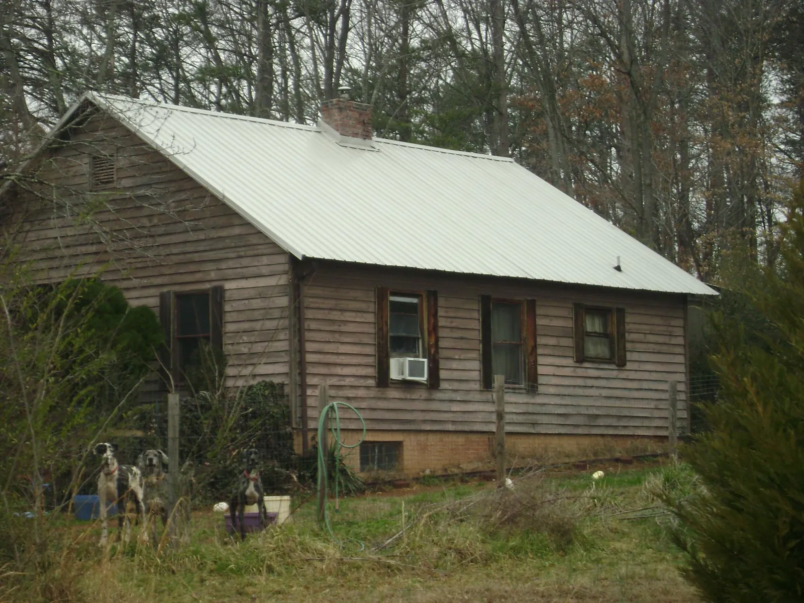 White metal roof on an old wood sided farmhouse, from a Metal Roof Installation job in Drakesboro